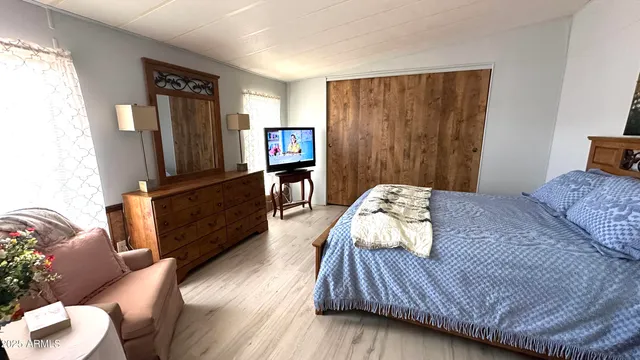 a bedroom with a bed and a dresser