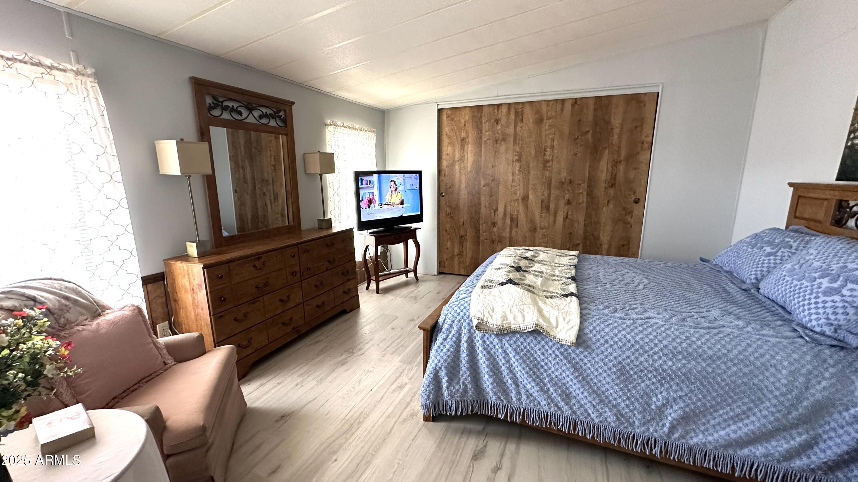 834 South Meridian Road, Unit 124 Apache Junction, AZ 85120 - Photo 21 of 28 a bedroom with a bed window and a television