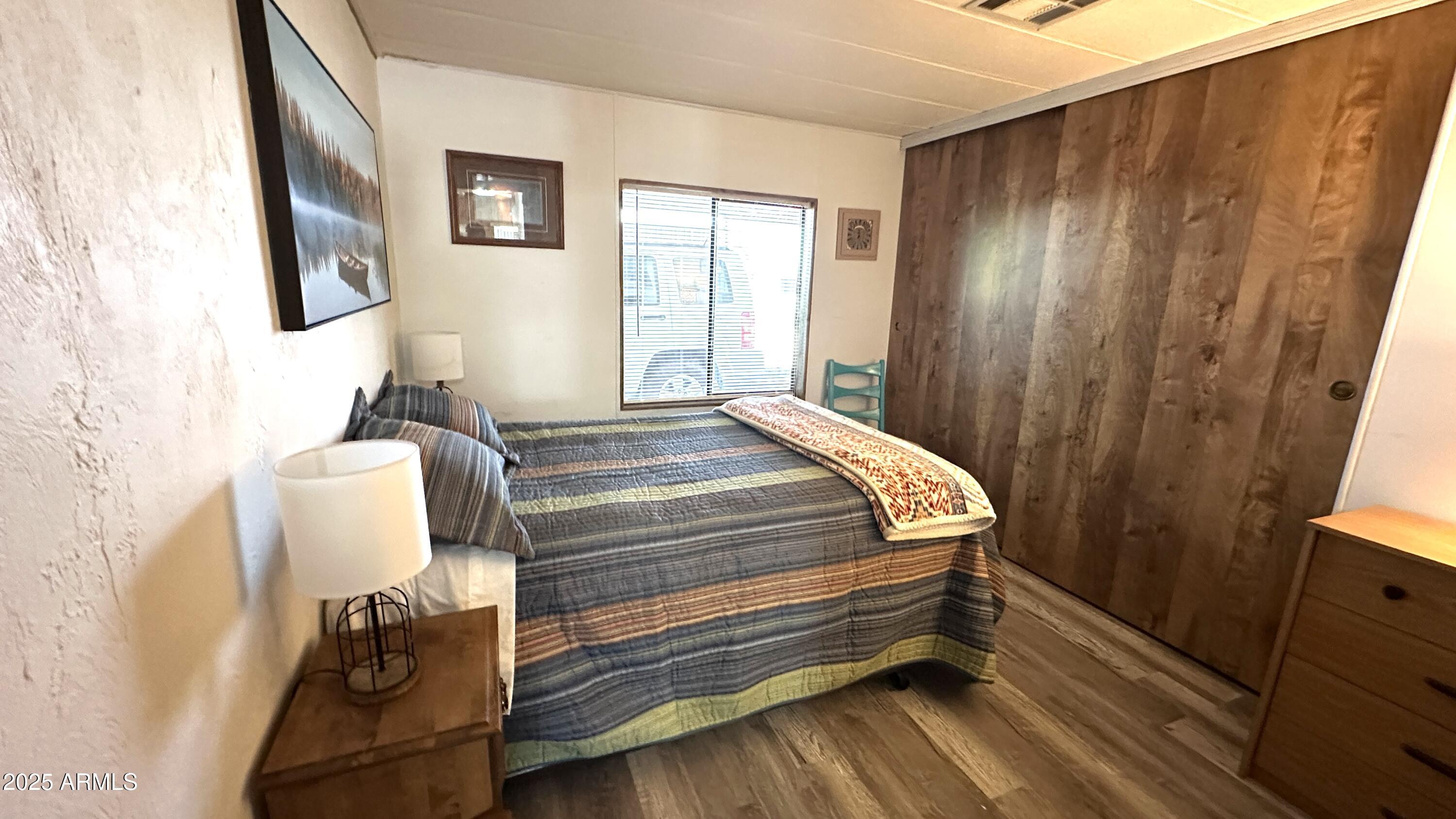 834 South Meridian Road, Unit 124 Apache Junction, AZ 85120 - Photo 24 of 28 a bedroom with a bed and a dresser