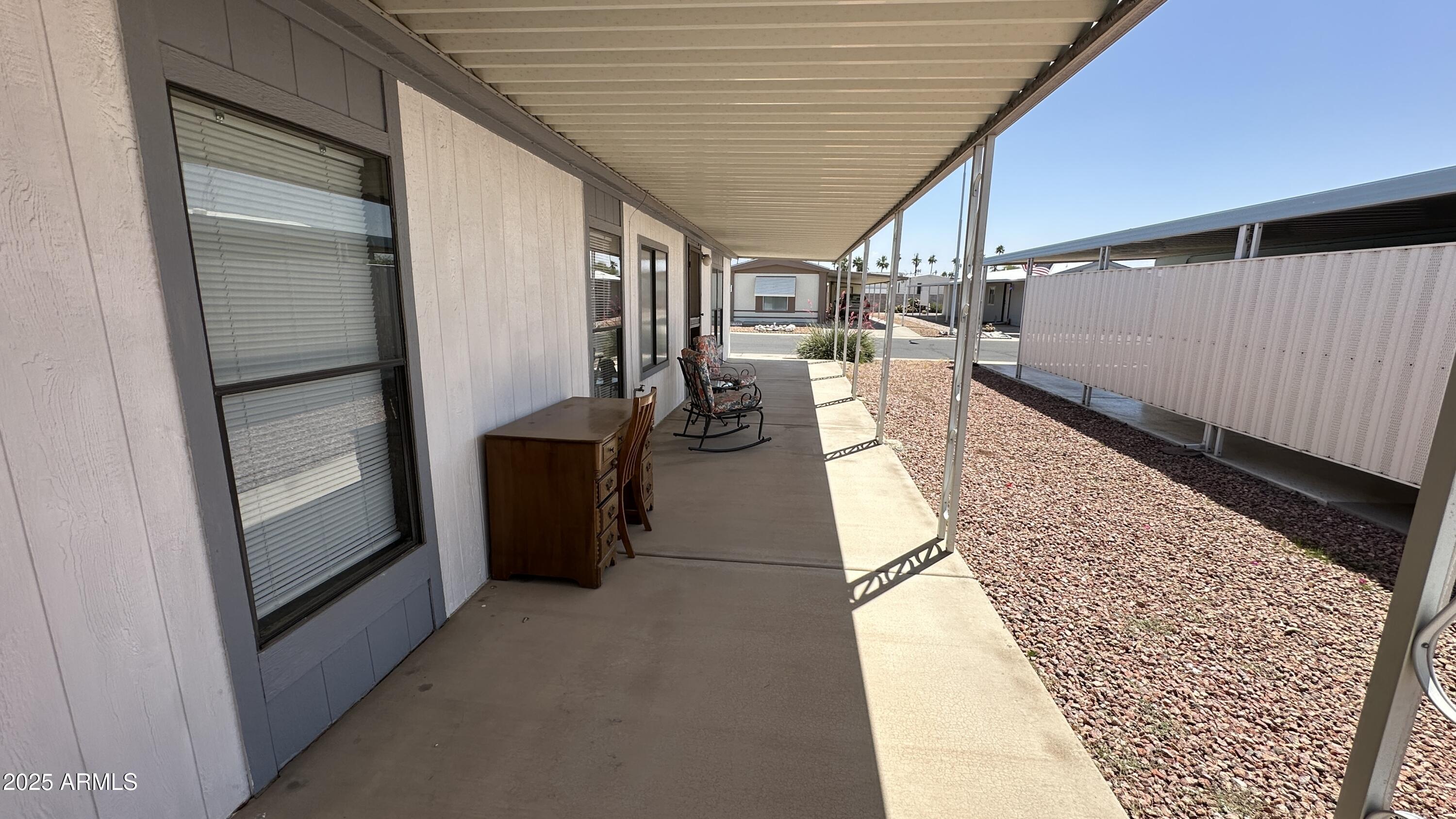 834 South Meridian Road, Unit 124 Apache Junction, AZ 85120 - Photo 7 of 28 a hallway with a large stone wall