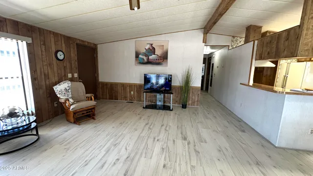 a kitchen with stainless steel appliances granite countertop table chairs and a large window