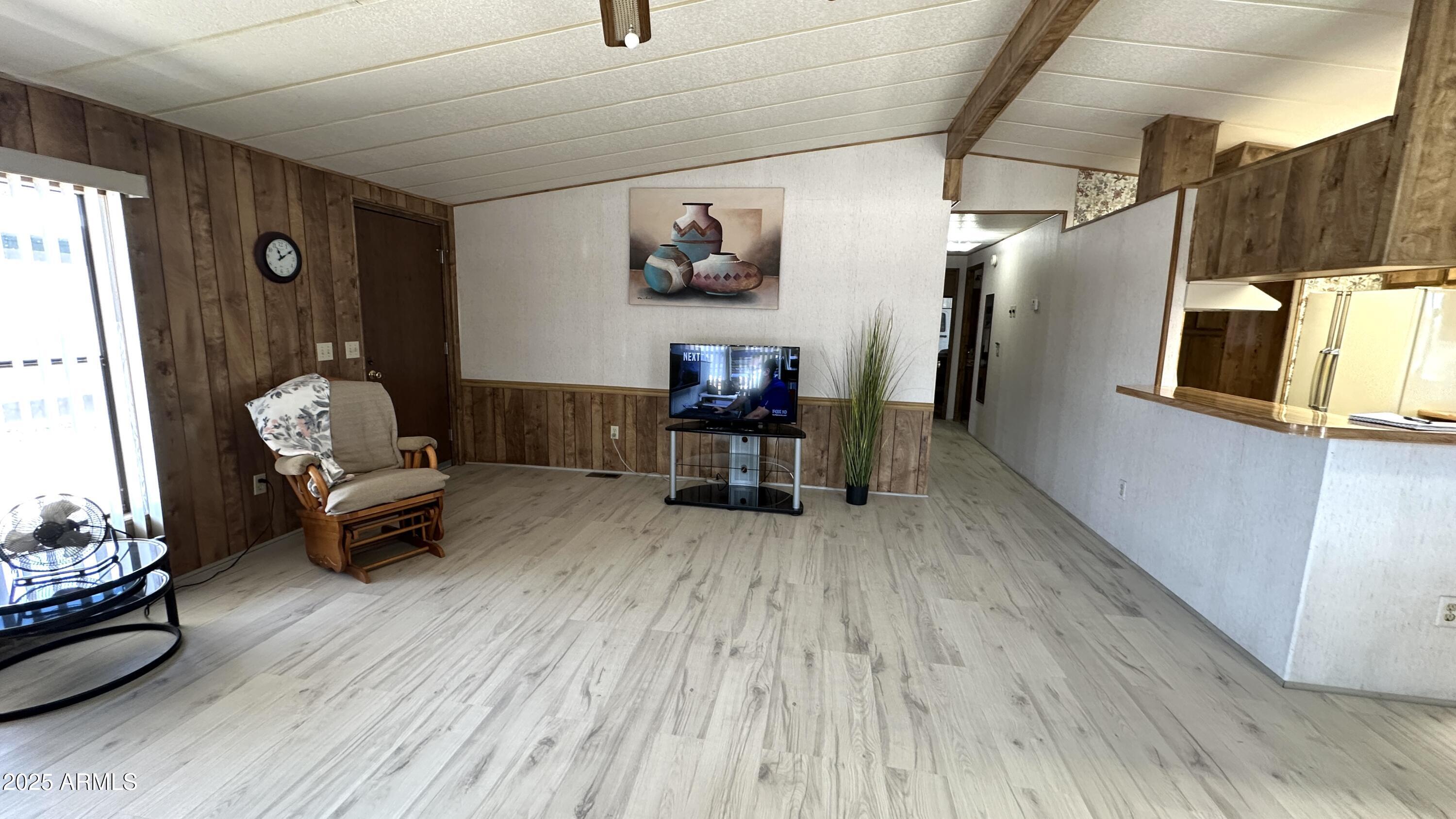 834 South Meridian Road, Unit 124 Apache Junction, AZ 85120 - Photo 10 of 28 a living room with furniture and a wooden floor