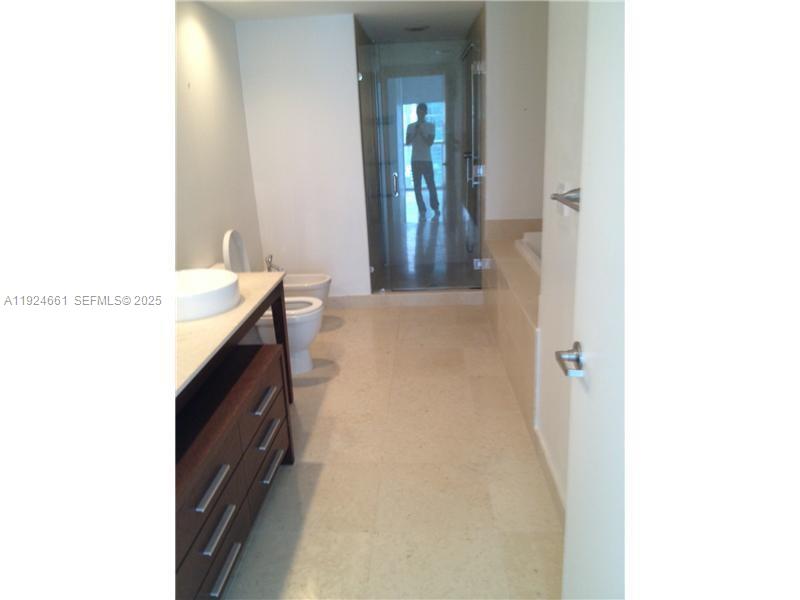 475 Brickell Avenue, Unit 2415 Miami, FL 33131 - Photo 4 of 9 a en suite bathroom with a sink