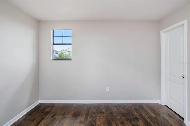 a view of room with window and hardwood floor