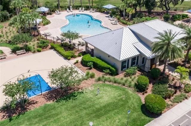 a aerial view of house with yard and swimming pool
