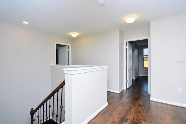 a view of hallway with wooden floor