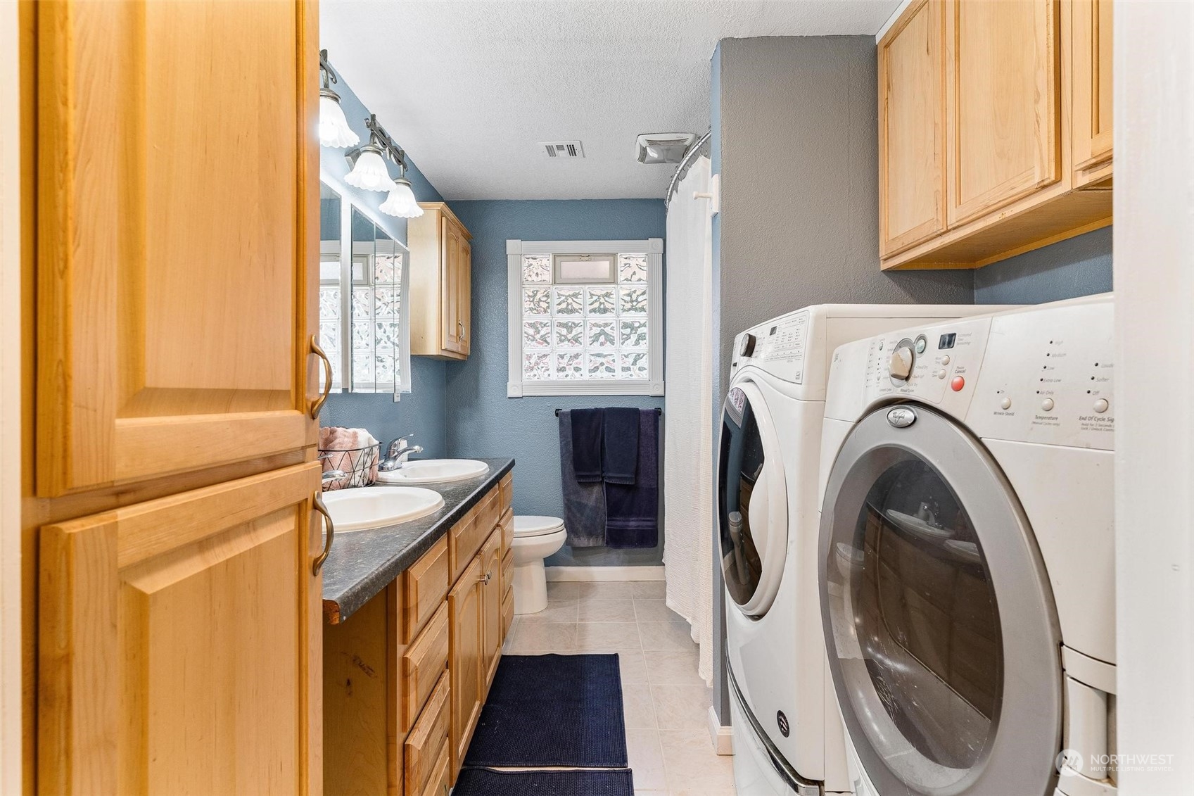 17821 Trombley Road Snohomish, WA 98290 - Photo 14 of 36 a bathroom with a sink a washer and dryer next to a window