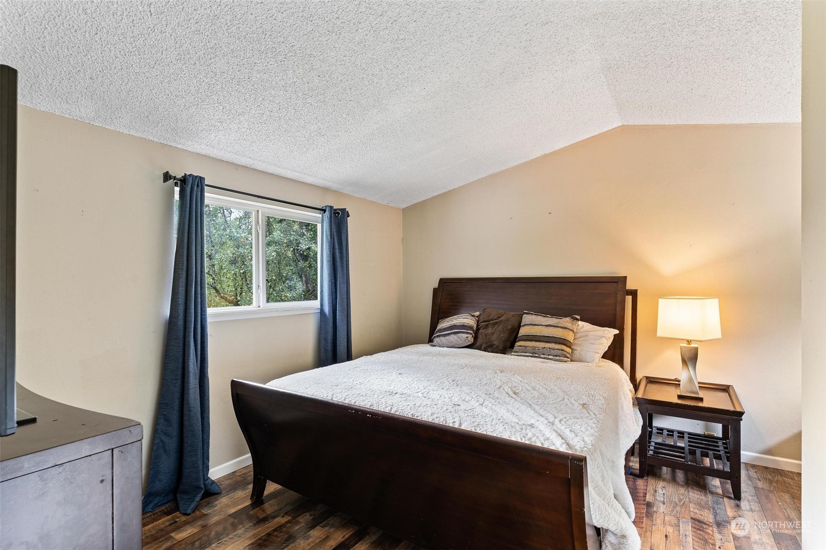 17821 Trombley Road Snohomish, WA 98290 - Photo 16 of 36 a bedroom with a bed and wooden floor