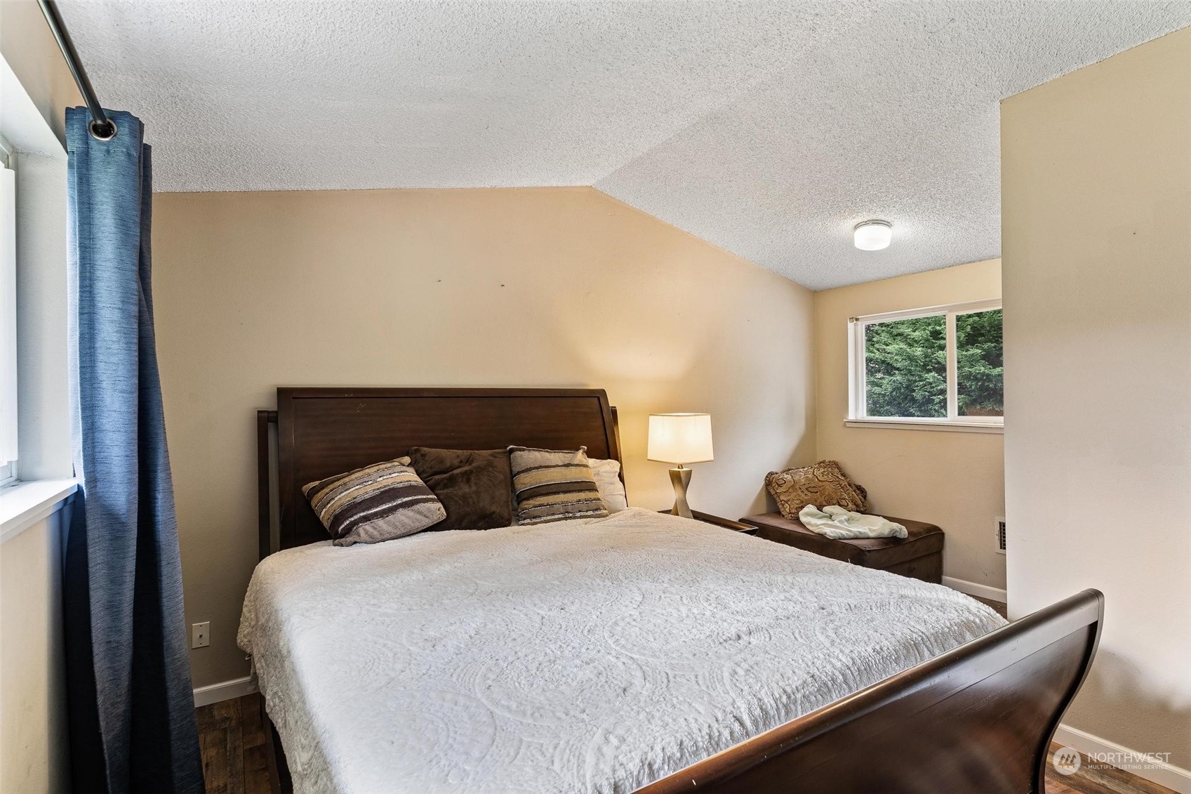 17821 Trombley Road Snohomish, WA 98290 - Photo 17 of 36 a bed sitting in a bedroom next to a window with a dresser