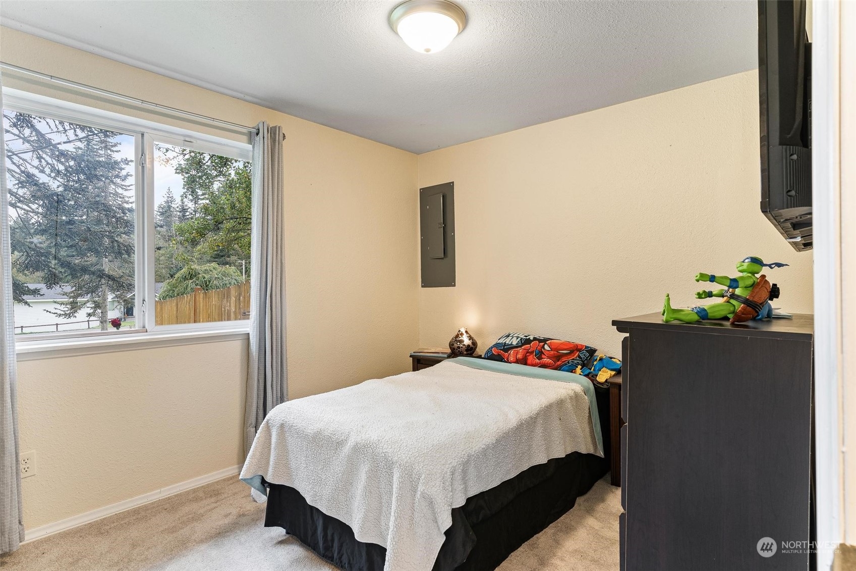 17821 Trombley Road Snohomish, WA 98290 - Photo 19 of 36 a bedroom with a bed and a flat tv screen on dresser