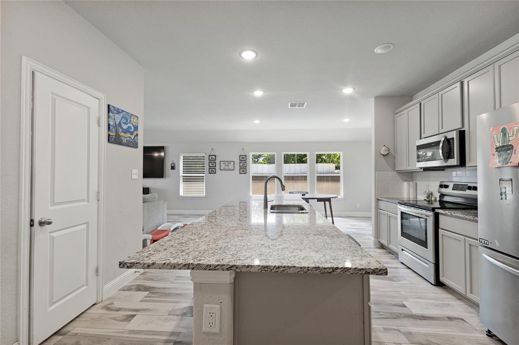 9221 White Settlement Road White Settlement, TX 76108 - Photo 13 of 30 a kitchen with granite countertop refrigerator and chairs