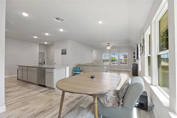 a kitchen with stainless steel appliances granite countertop a refrigerator and a sink
