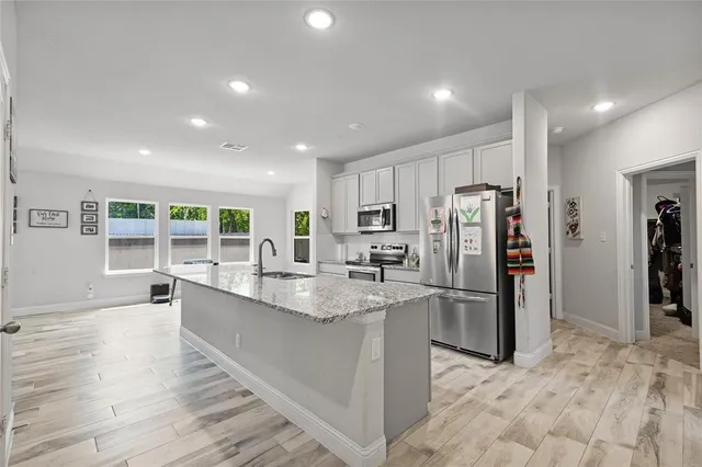a kitchen with sink and center island