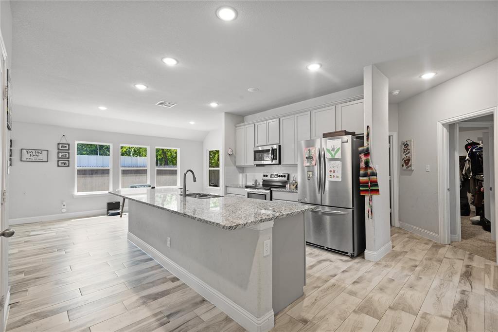 9221 White Settlement Road White Settlement, TX 76108 - Photo 17 of 30 a kitchen with stainless steel appliances granite countertop a refrigerator and a sink