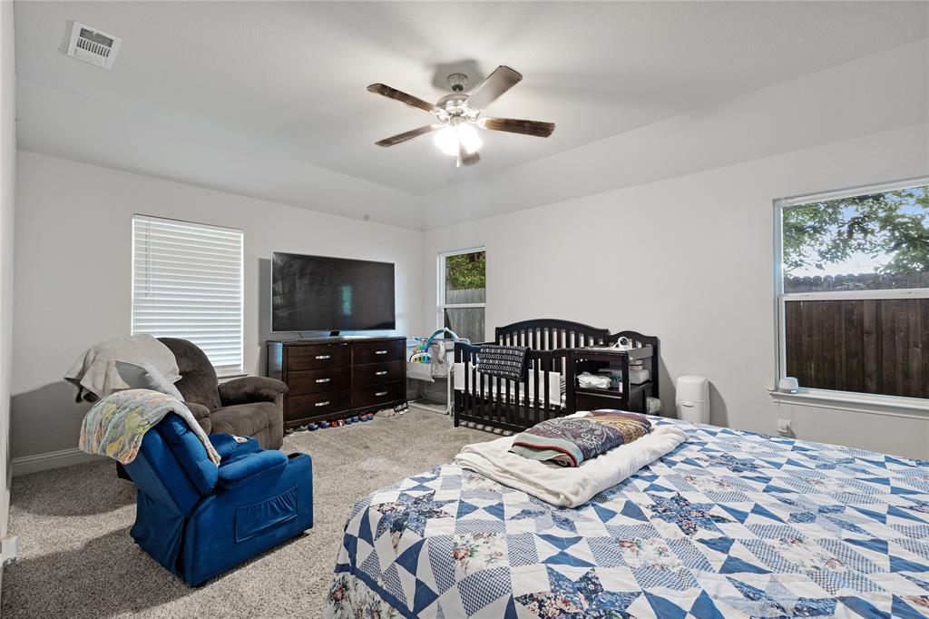 9221 White Settlement Road White Settlement, TX 76108 - Photo 20 of 30 a bedroom with a large bed and a flat screen tv