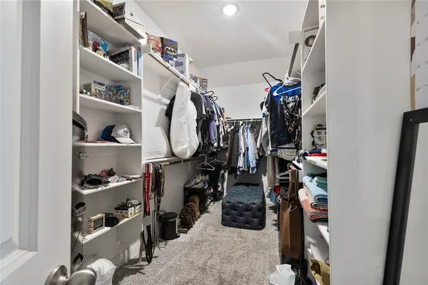 a bathroom with double vanity sinks a toilet a shower a vanity and a mirror