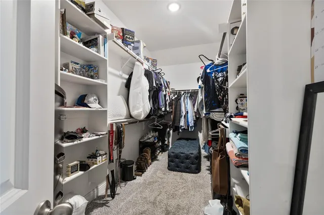 a bathroom with double vanity sinks a toilet a shower a vanity and a mirror