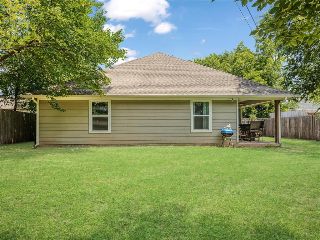 9221 White Settlement Road White Settlement, TX 76108 - Photo 29 of 30 a front view of a house with a garden
