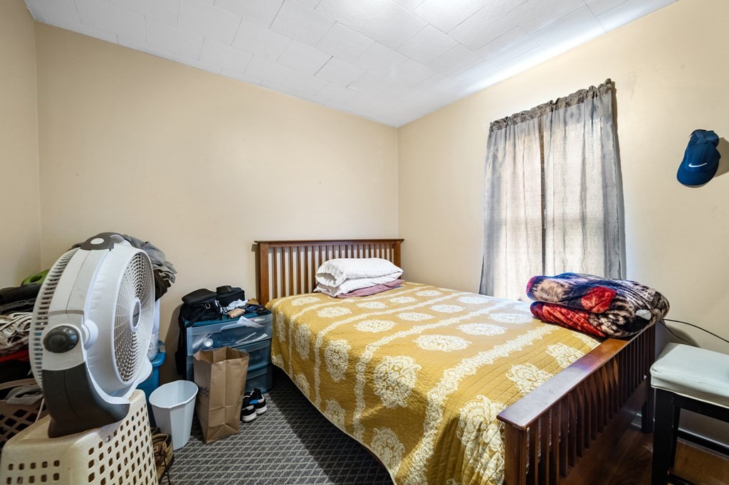 16 Barclay Street Worcester, MA 01604 - Photo 11 of 20 a bedroom with a bed and wooden floor