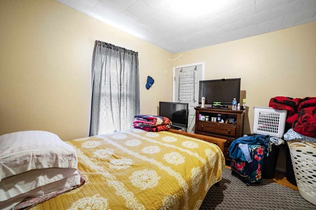 16 Barclay Street Worcester, MA 01604 - Photo 12 of 20 a bedroom with a bed and a flat screen tv