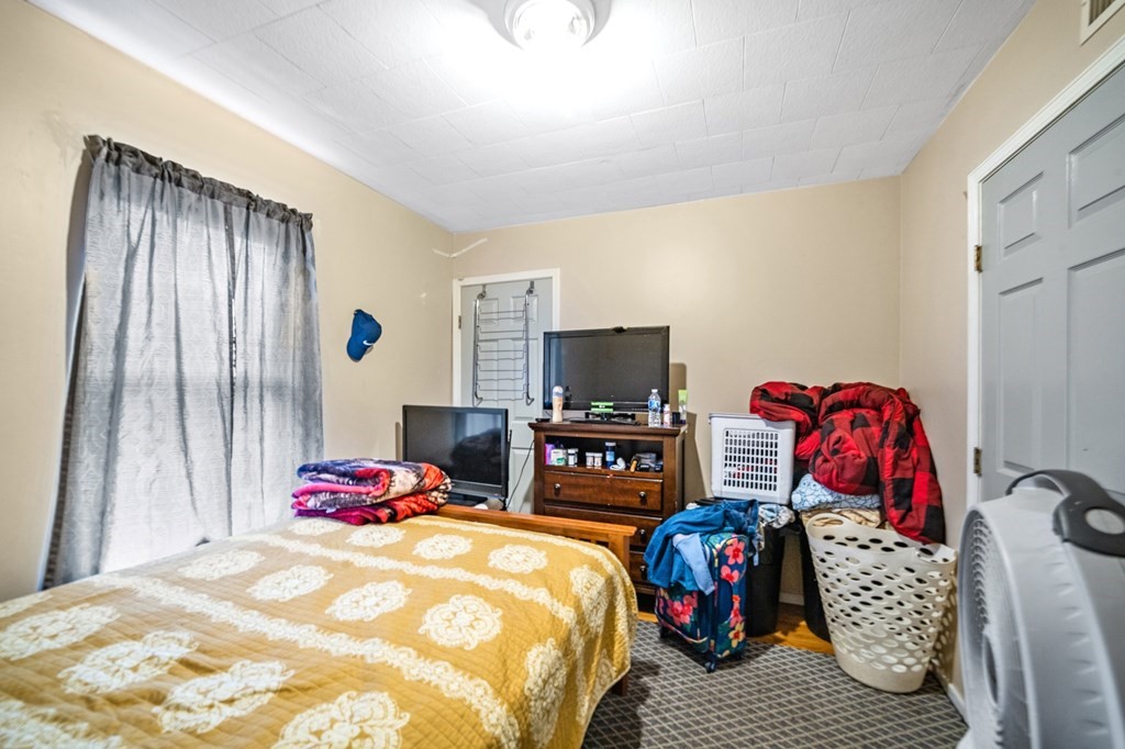 16 Barclay Street Worcester, MA 01604 - Photo 13 of 20 a bedroom with a bed and flat screen tv