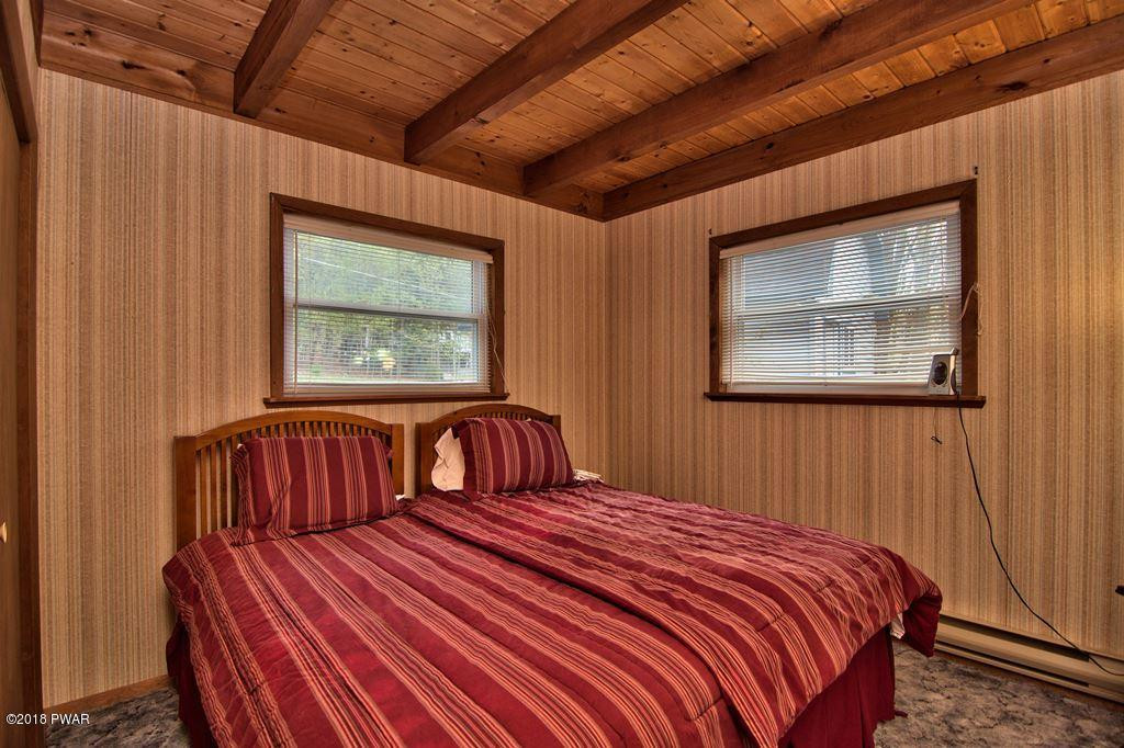 2327 Brookfield Road Lake Ariel, PA 18436 - Photo 17 of 53 a bedroom with a bed and wooden floor
