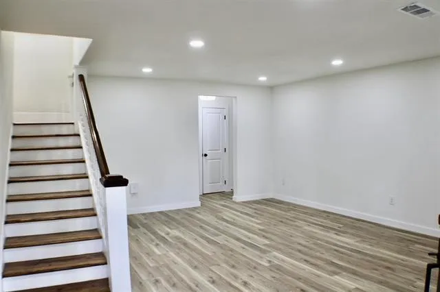 a view of entryway with wooden floor and stairs