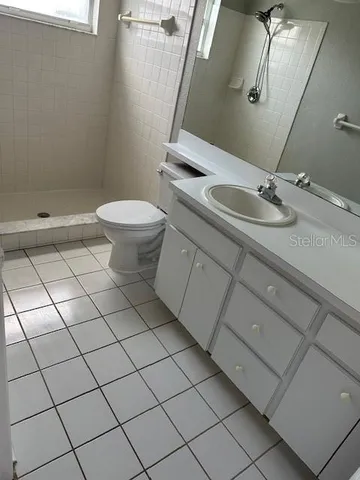 a bathroom with a sink toilet and mirror