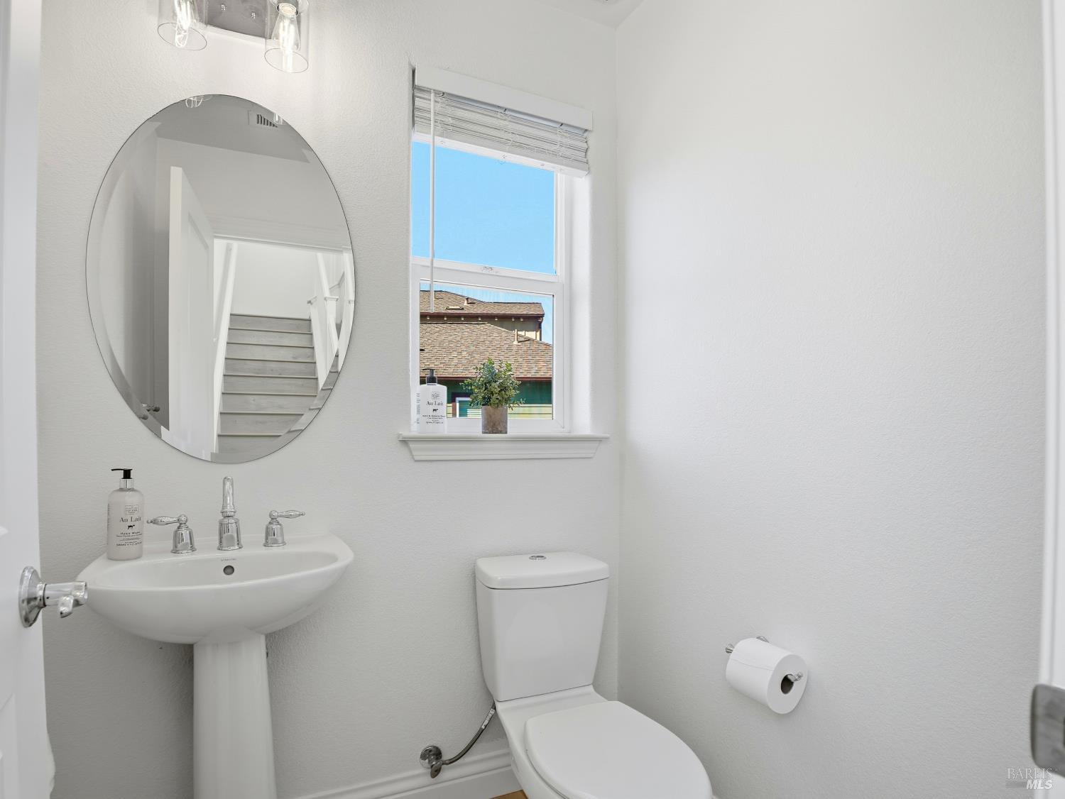 4424 Streamside Drive Santa Rosa, CA 95409 - Photo 24 of 55 a bathroom with a toilet sink and mirror