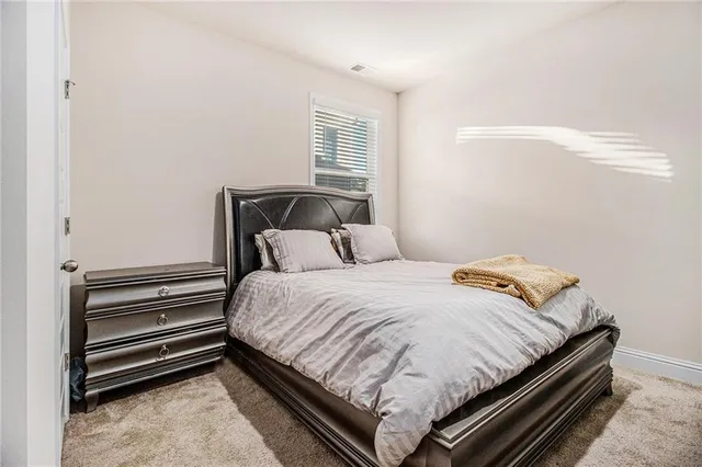 a bedroom with a bed and windows