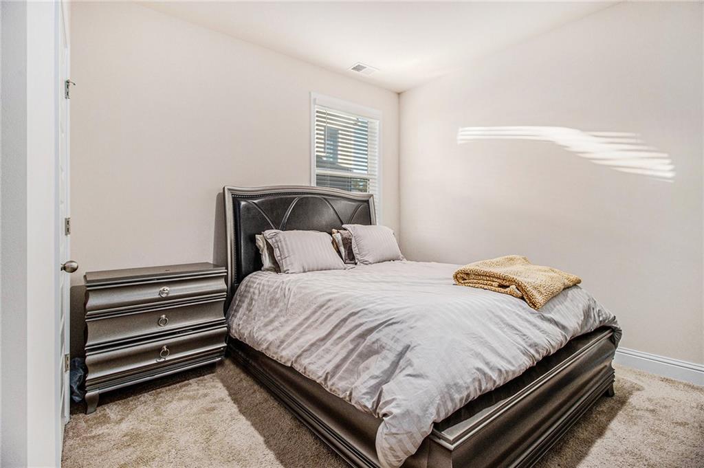 316 Conley Avenue Hampton, GA 30228 - Photo 13 of 27 a bedroom with a bed and windows