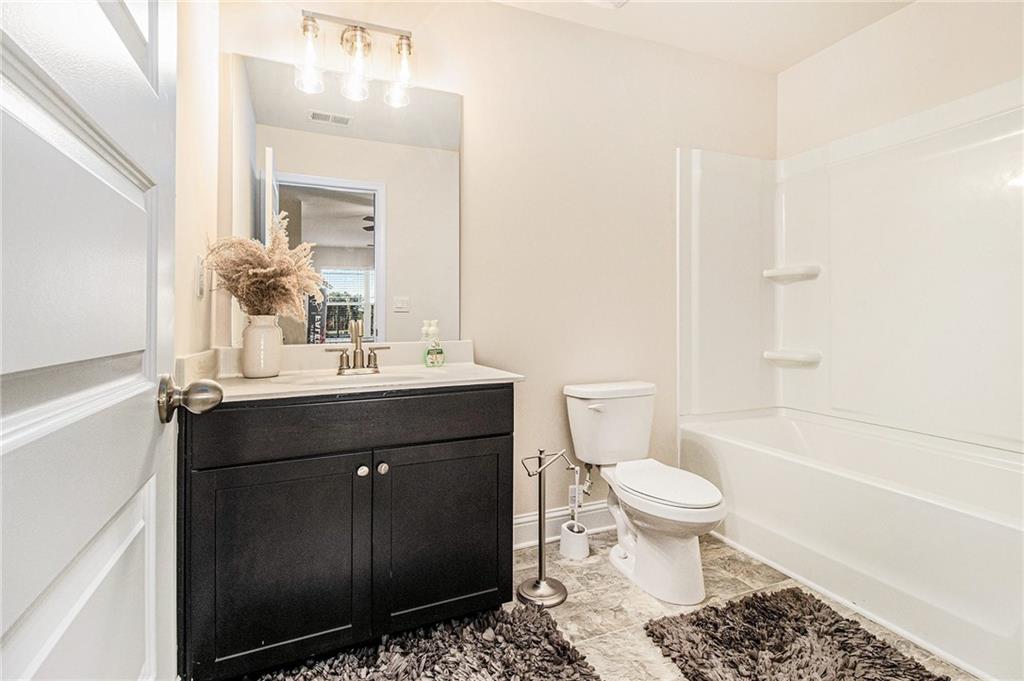 316 Conley Avenue Hampton, GA 30228 - Photo 14 of 27 a bathroom with a sink toilet and shower