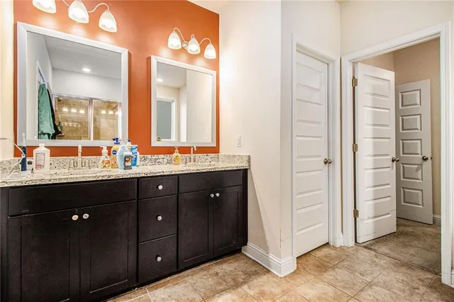 a bathroom with a double vanity sink and a mirror