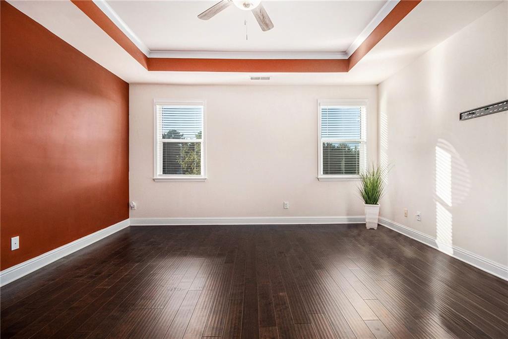 316 Conley Avenue Hampton, GA 30228 - Photo 16 of 27 an empty room with wooden floor and windows