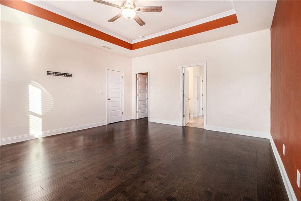 316 Conley Avenue Hampton, GA 30228 - Photo 17 of 27 an empty room with wooden floor fan and windows