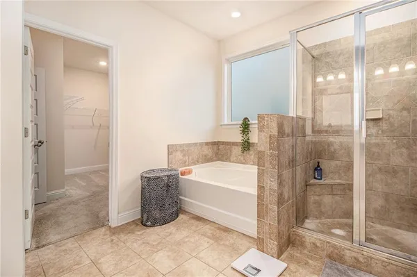 a bathroom with a bathtub and a shower
