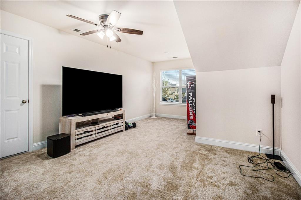 316 Conley Avenue Hampton, GA 30228 - Photo 20 of 27 a living room with furniture and a flat screen tv