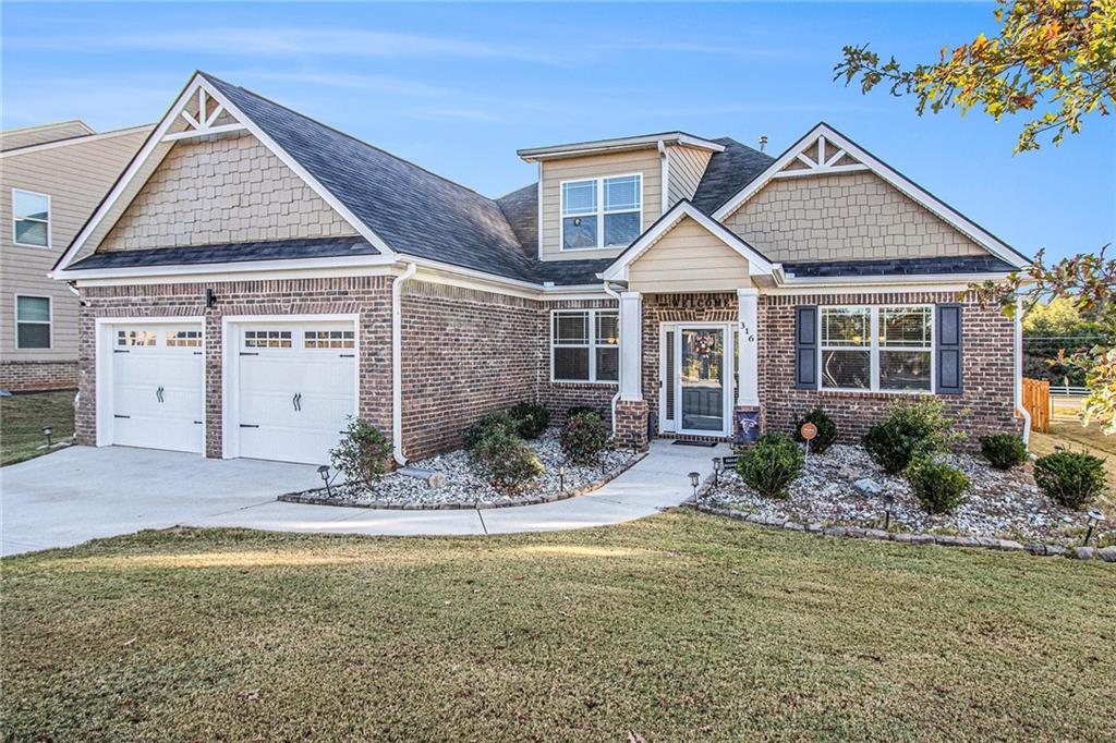 316 Conley Avenue Hampton, GA 30228 - Photo 2 of 27 a front view of a house with a garden