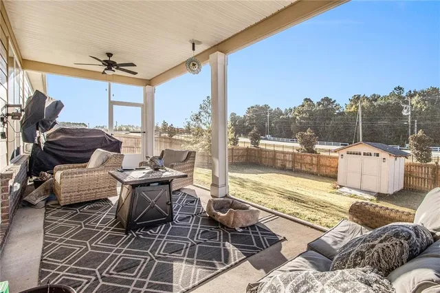 a view of a patio with couches chairs and wooden floor