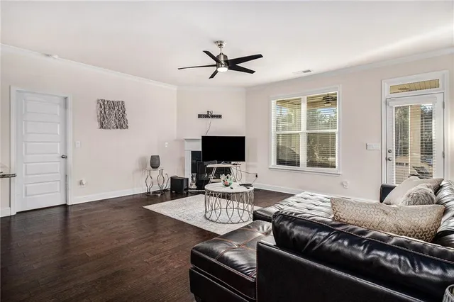 a living room with furniture wooden floor and a flat screen tv