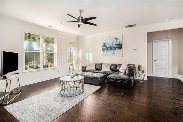 a living room with furniture wooden floor and a flat screen tv