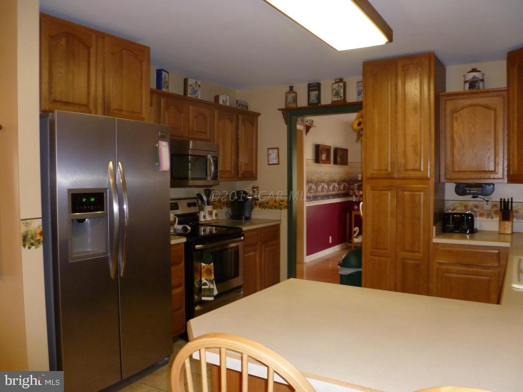 35484 Poplar Neck Road Willards, MD 21874 - Photo 7 of 15 a kitchen with stainless steel appliances granite countertop a refrigerator a stove and a sink