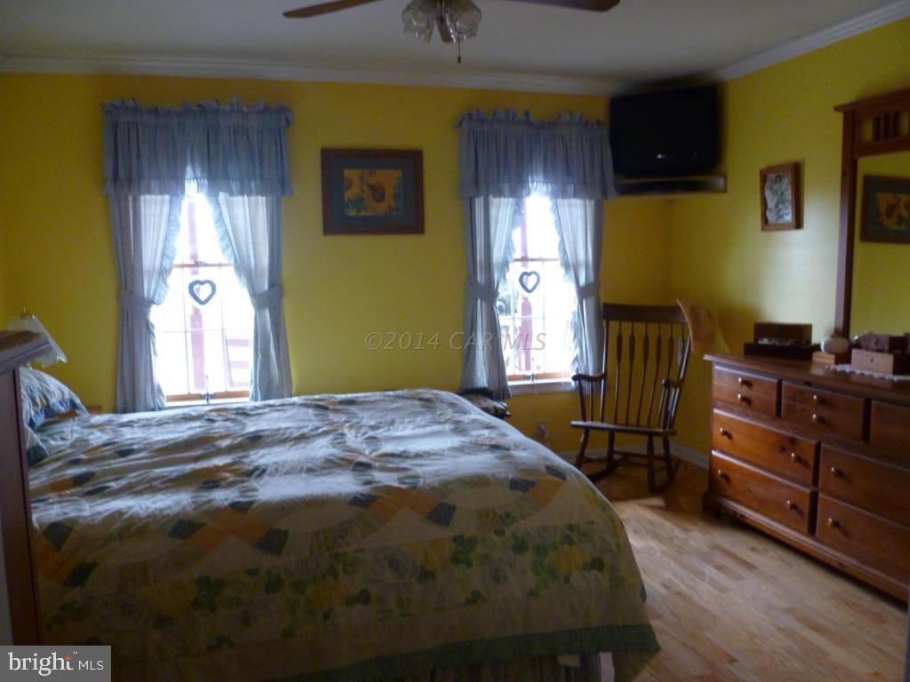 35484 Poplar Neck Road Willards, MD 21874 - Photo 9 of 15 a bedroom with a bed and a dresser