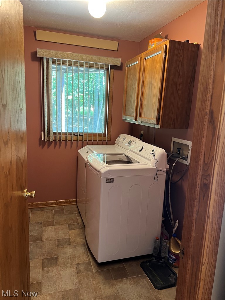 7129 State Rte 5 Ravenna, OH 44266 - Photo 22 of 28 Washroom featuring dark tile floors and washer / dryer