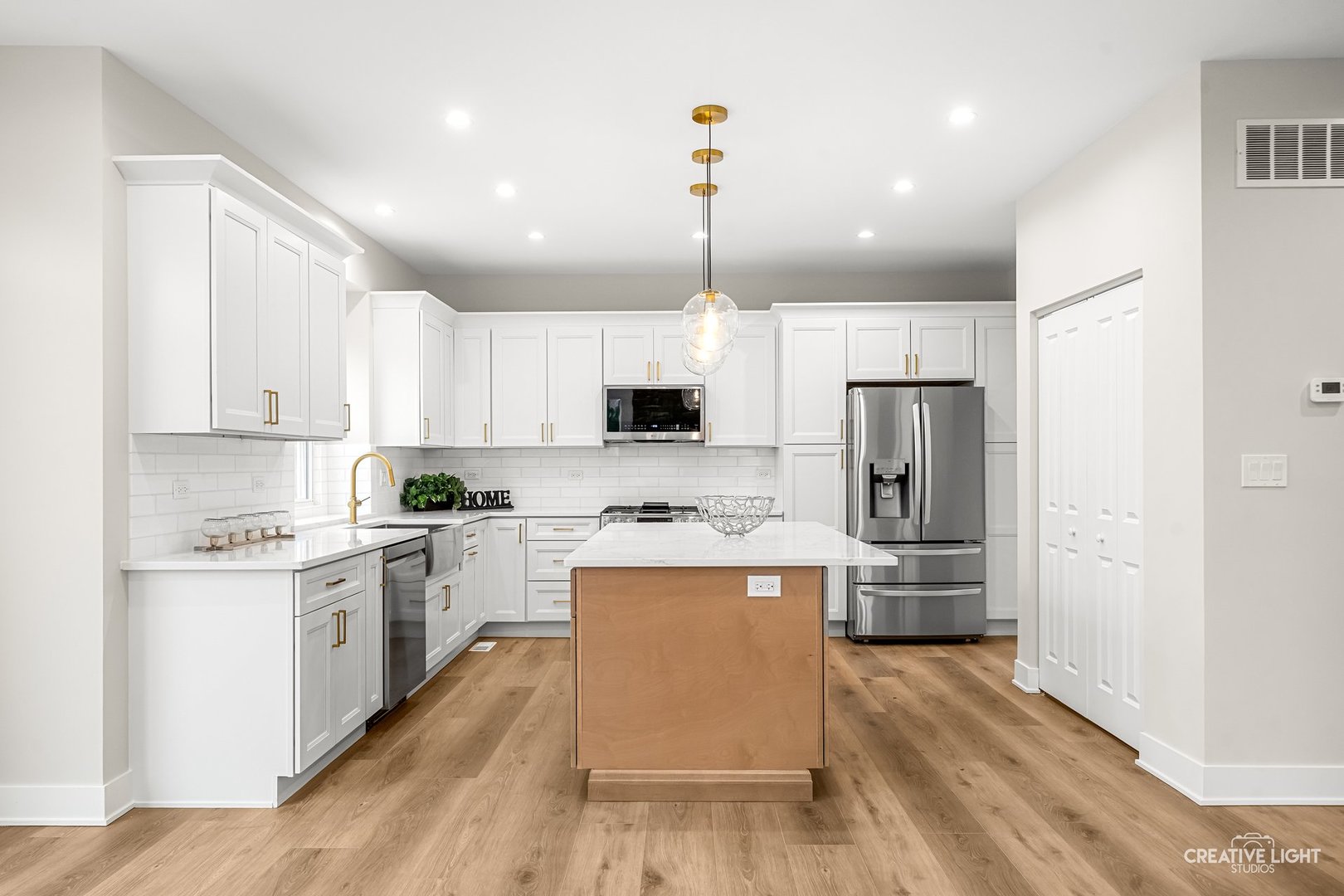 1472 Misty Lane Bolingbrook, IL 60490 - Photo 13 of 40 a large kitchen with cabinets wooden floor and stainless steel appliances