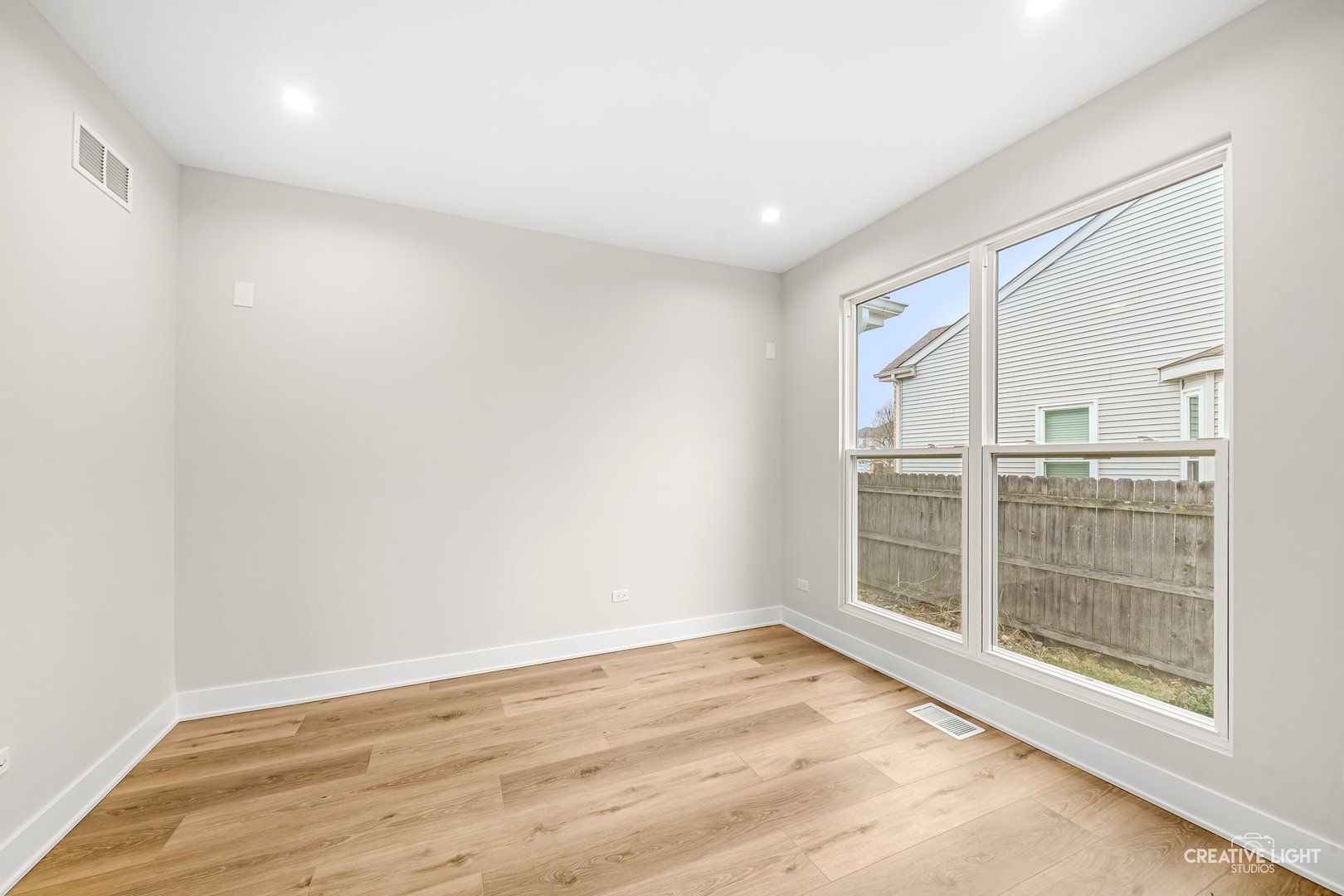 1472 Misty Lane Bolingbrook, IL 60490 - Photo 19 of 40 an empty room with wooden floor and windows