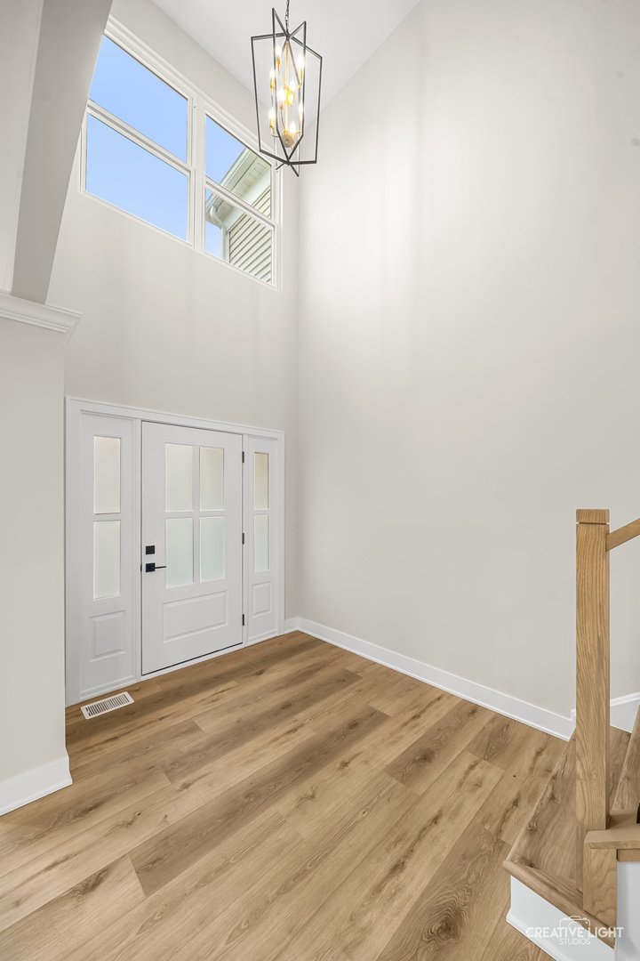 1472 Misty Lane Bolingbrook, IL 60490 - Photo 2 of 40 a view of a room with wooden floor and chandelier