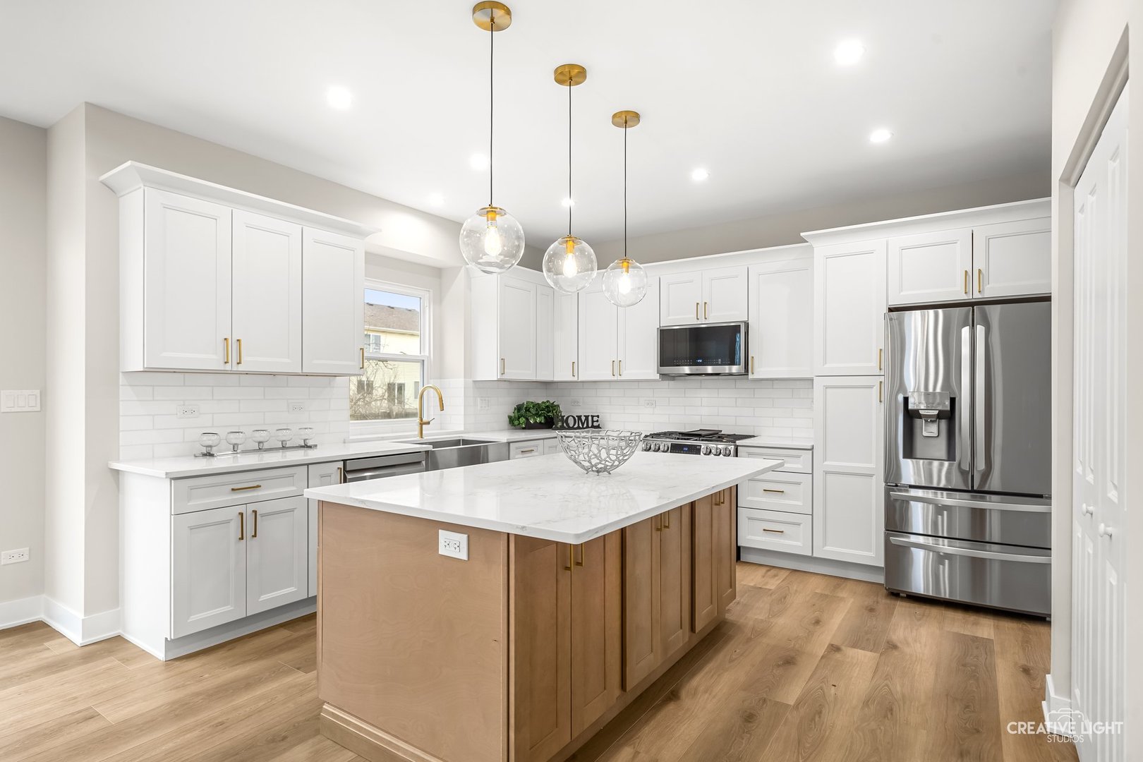 1472 Misty Lane Bolingbrook, IL 60490 - Photo 8 of 40 a kitchen with stainless steel appliances granite countertop a refrigerator a sink dishwasher a stove with white cabinets and wooden floor