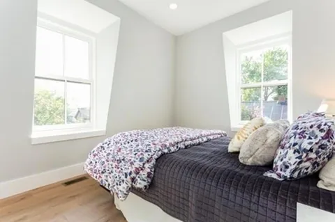 a bedroom with a bed and window