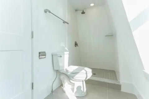 a white toilet sitting next to a bathroom sink